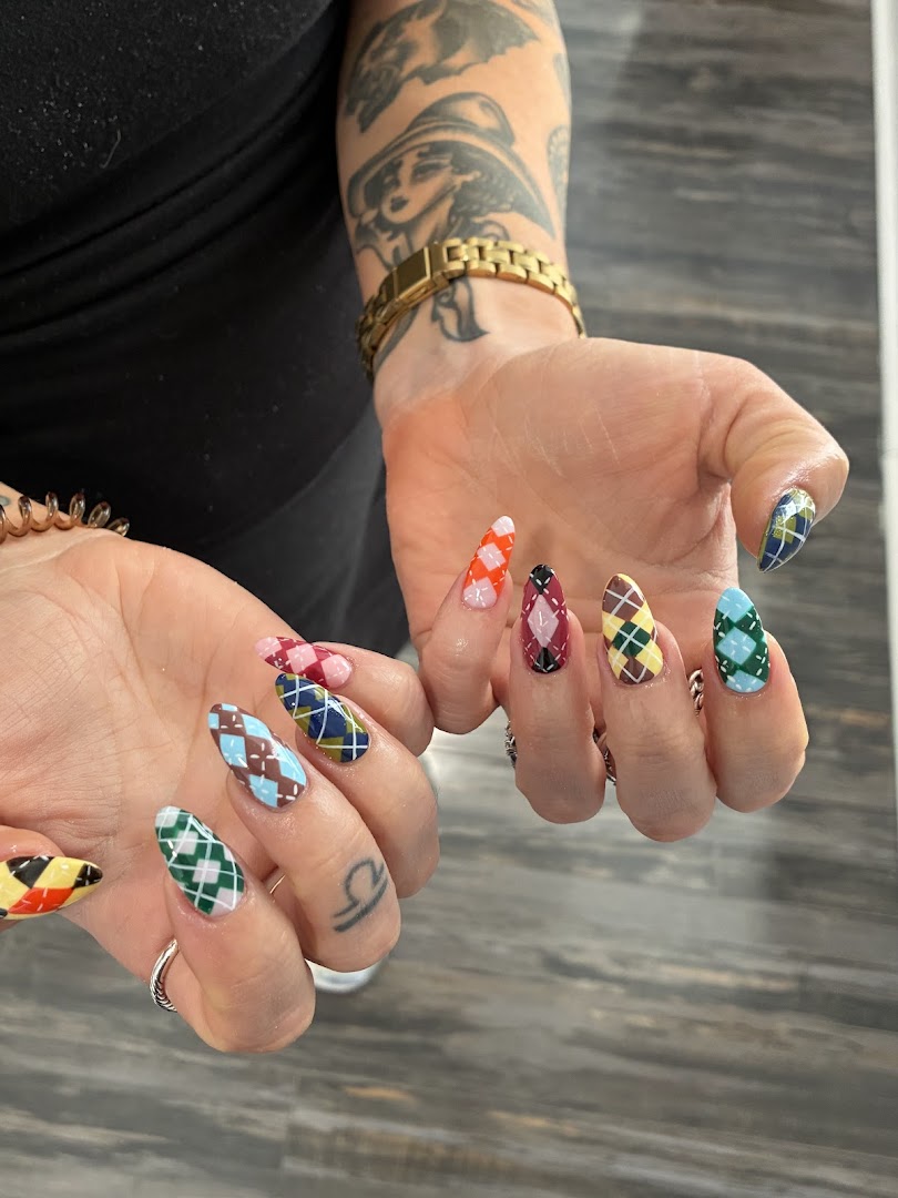 Colorful argyle pattern nail art displayed on both hands